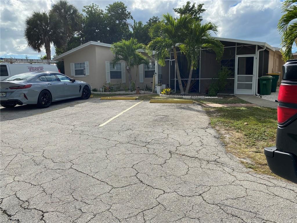 2084 Monroe Avenue Naples, FL 34112 - Photo 1 of 10 a front view of a house with garden
