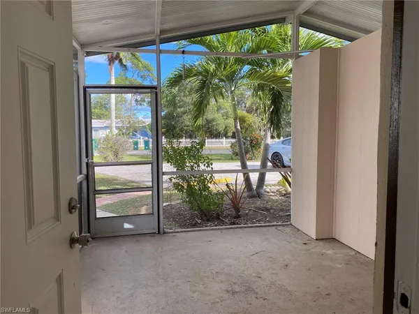 an empty room with windows and stairs