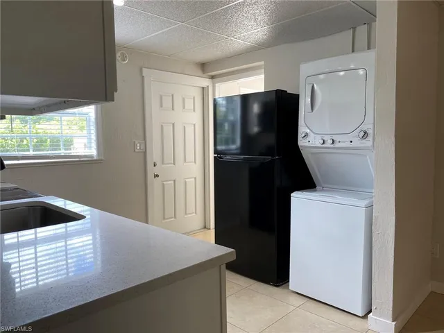 a kitchen with a refrigerator and tub