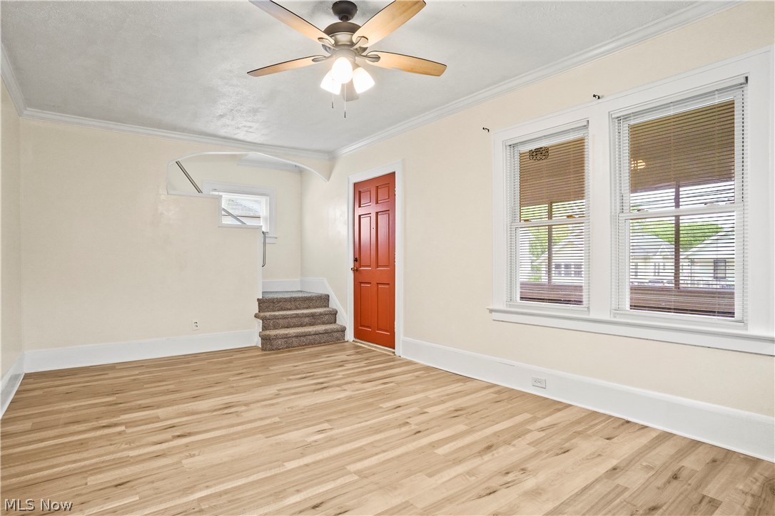 688 Ranney Street Akron, OH 44310 - Photo 13 of 35 Empty room featuring ornamental molding, ceiling fan, and light wood-type flooring