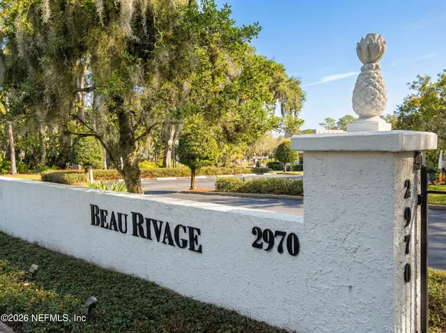 a living room with furniture and large window