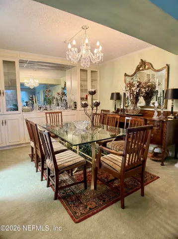 a room with furniture pool table and window