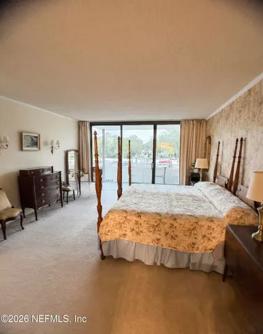 a dining room with furniture a chandelier and a rug