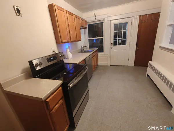 a kitchen with a stove and a refrigerator