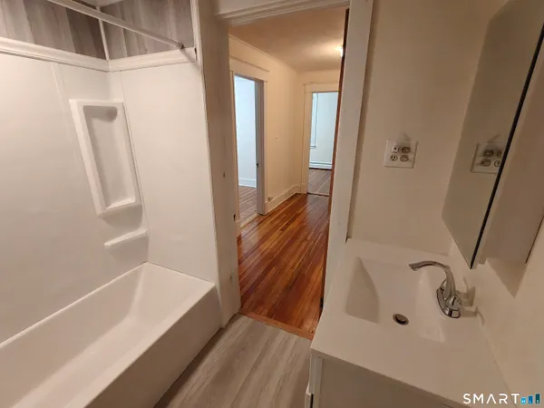 a bathroom with a bathtub and a shower