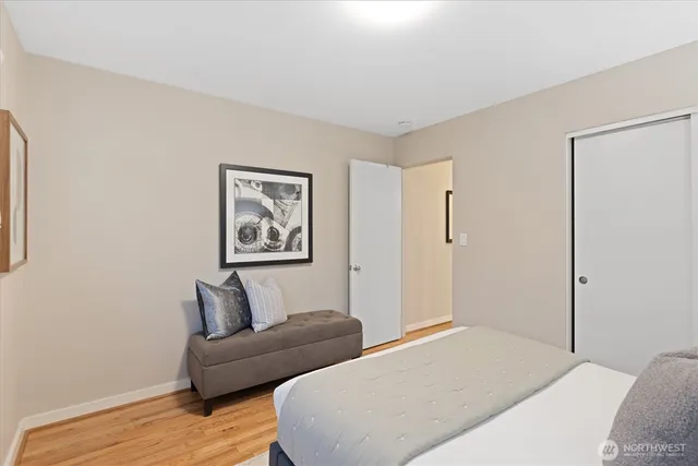 a bedroom with furniture and a wooden floor