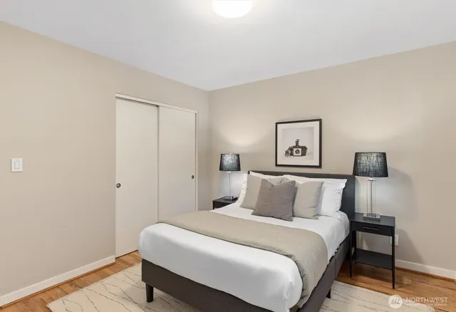 a bedroom with a bed and a night stand