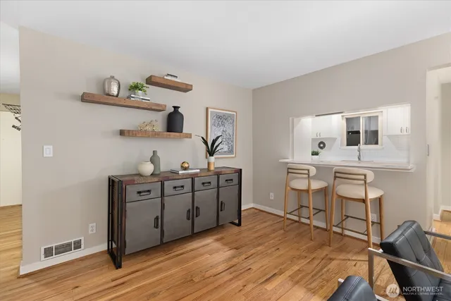 a kitchen with stainless steel appliances a stove a sink cabinets and wooden floor