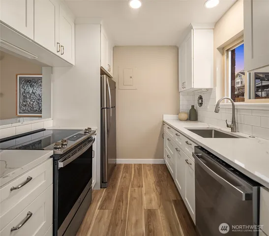 a kitchen with a sink stove and refrigerator