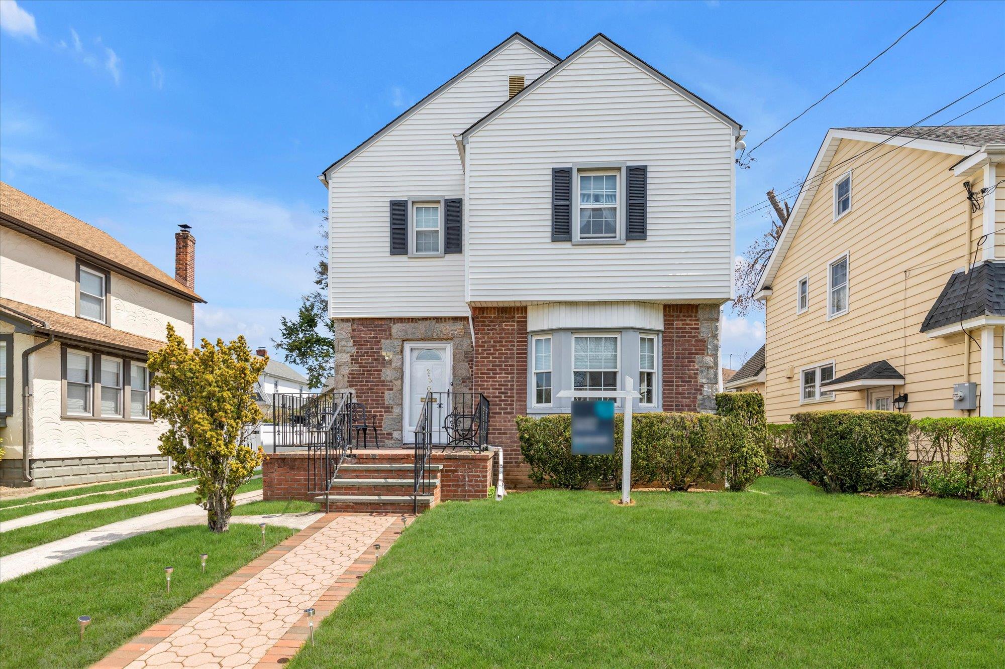 230 Kensington Road Lynbrook, NY 11563 - Photo 1 of 1 a front view of a house with a yard