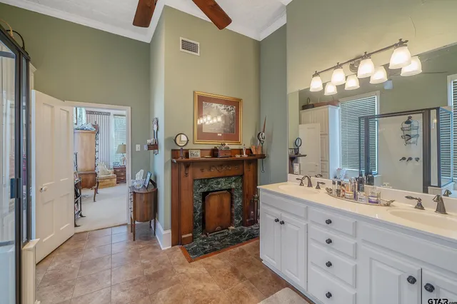 a spacious bathroom with a double vanity sink a mirror and a shower