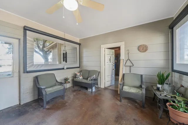 a living room with furniture and a potted plant