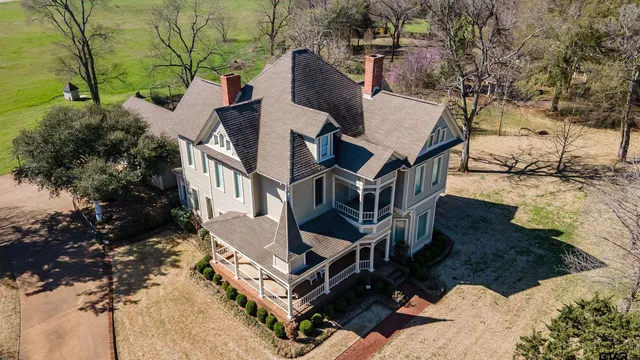 an aerial view of a house with a yard