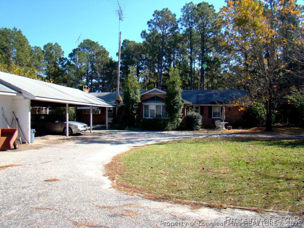 1615 Midland Road Southern Pines, NC 28387 - Photo 1 of 12 a view of a house with swimming pool and sitting area