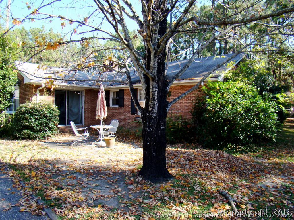 1615 Midland Road Southern Pines, NC 28387 - Photo 2 of 12 a view of a house with backyard porch and sitting area