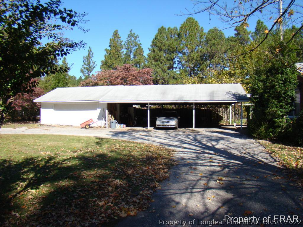 1615 Midland Road Southern Pines, NC 28387 - Photo 3 of 12 a view of a house with a yard and tree s