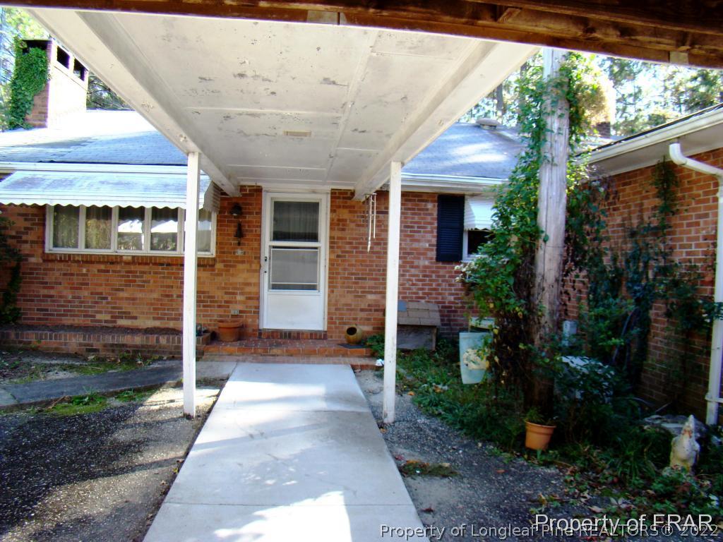 1615 Midland Road Southern Pines, NC 28387 - Photo 4 of 12 a front view of a house with garden
