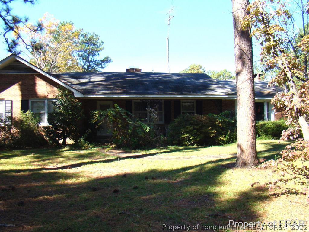 1615 Midland Road Southern Pines, NC 28387 - Photo 8 of 12 a view of house with yard and garage