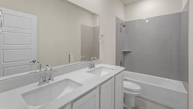 a bathroom with a sink toilet vanity and shower