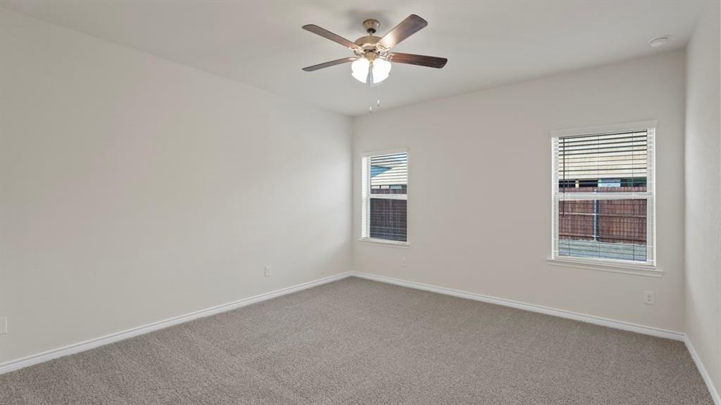 2424 Palo Pinto Trail Pilot Point, TX 76258 - Photo 13 of 39 an empty room with a window and a fan