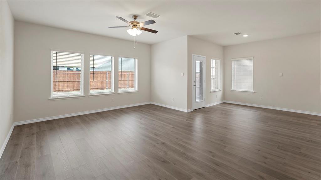 2424 Palo Pinto Trail Pilot Point, TX 76258 - Photo 31 of 39 a view of an empty room with a window and wooden floor