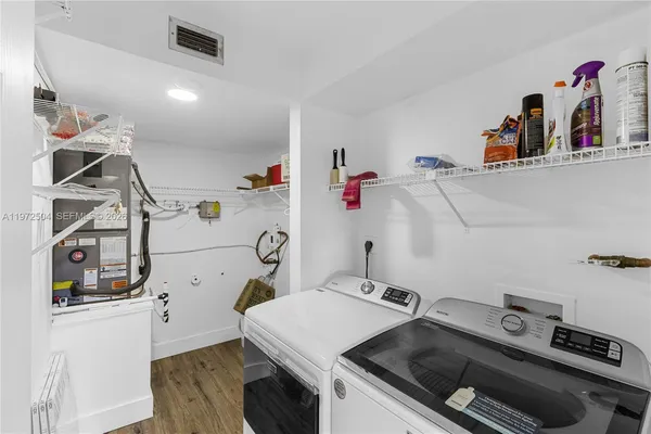 a utility room with sink dryer and washer
