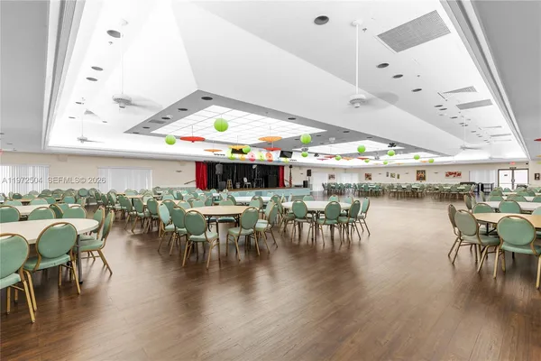 a dining room with lots of furniture and wooden floor