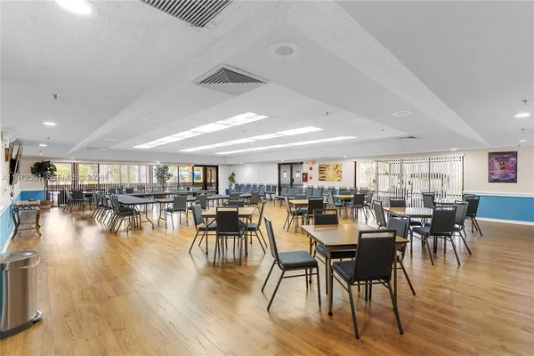 a view of a dining hall with furniture and wooden floor