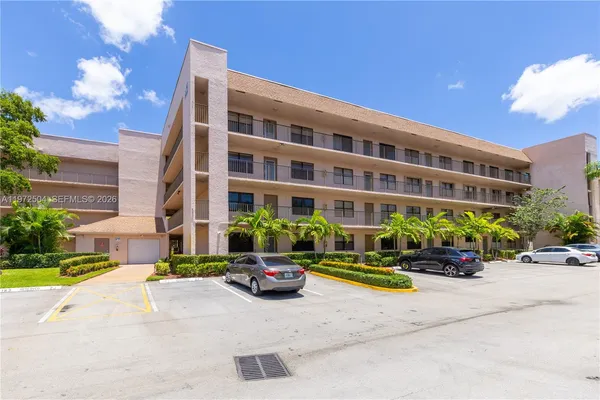 a front view of a building with flower garden