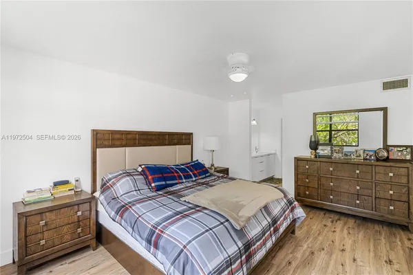 a bedroom with a bed and a dresser