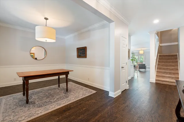 a view of a livingroom with wooden floor and a potted plant