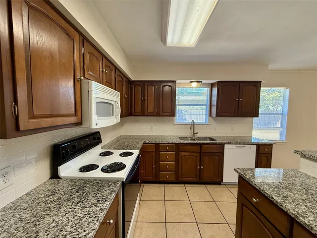a kitchen with a stove and a refrigerator