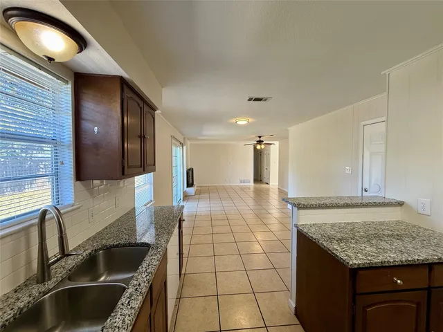 a kitchen with granite countertop a stove and a sink