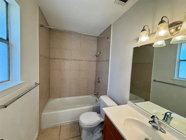a bathroom with a sink toilet tub and shower