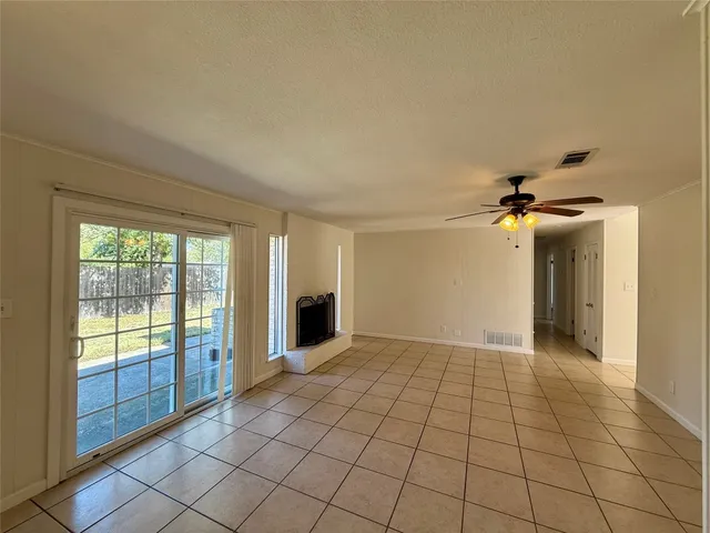 a view of an empty room with glass door