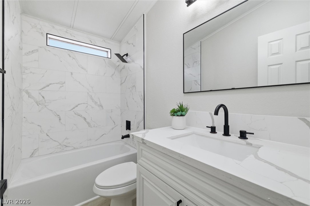 3940 Point Drive Pahrump, NV 89060 - Photo 27 of 35 A well-appointed bathroom features a bathtub, an integrated shower, and a pristine vanity.