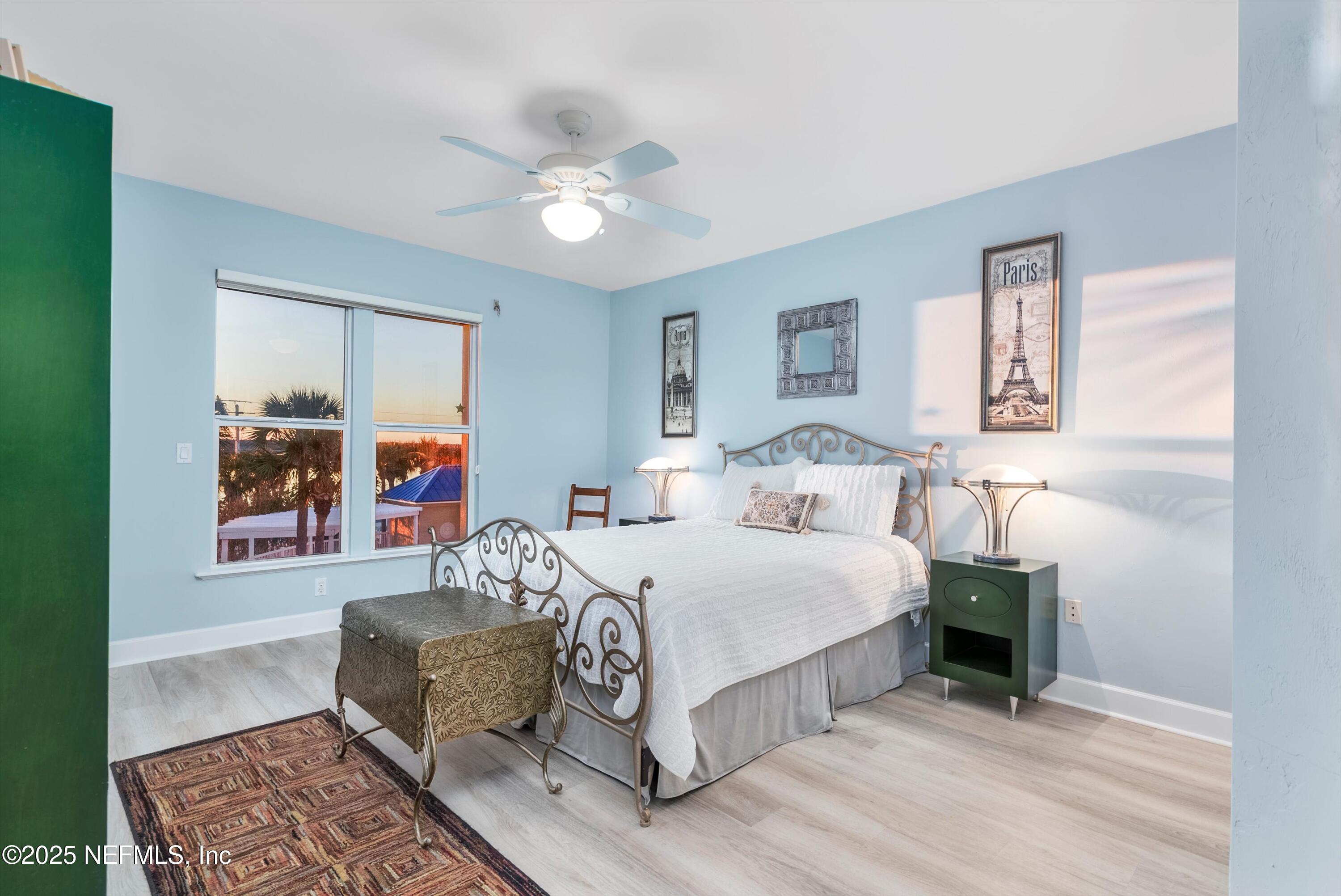 7790 A1A South, Unit 104 St. Augustine, FL 32080 - Photo 11 of 51 a bedroom with a bed and a chandelier