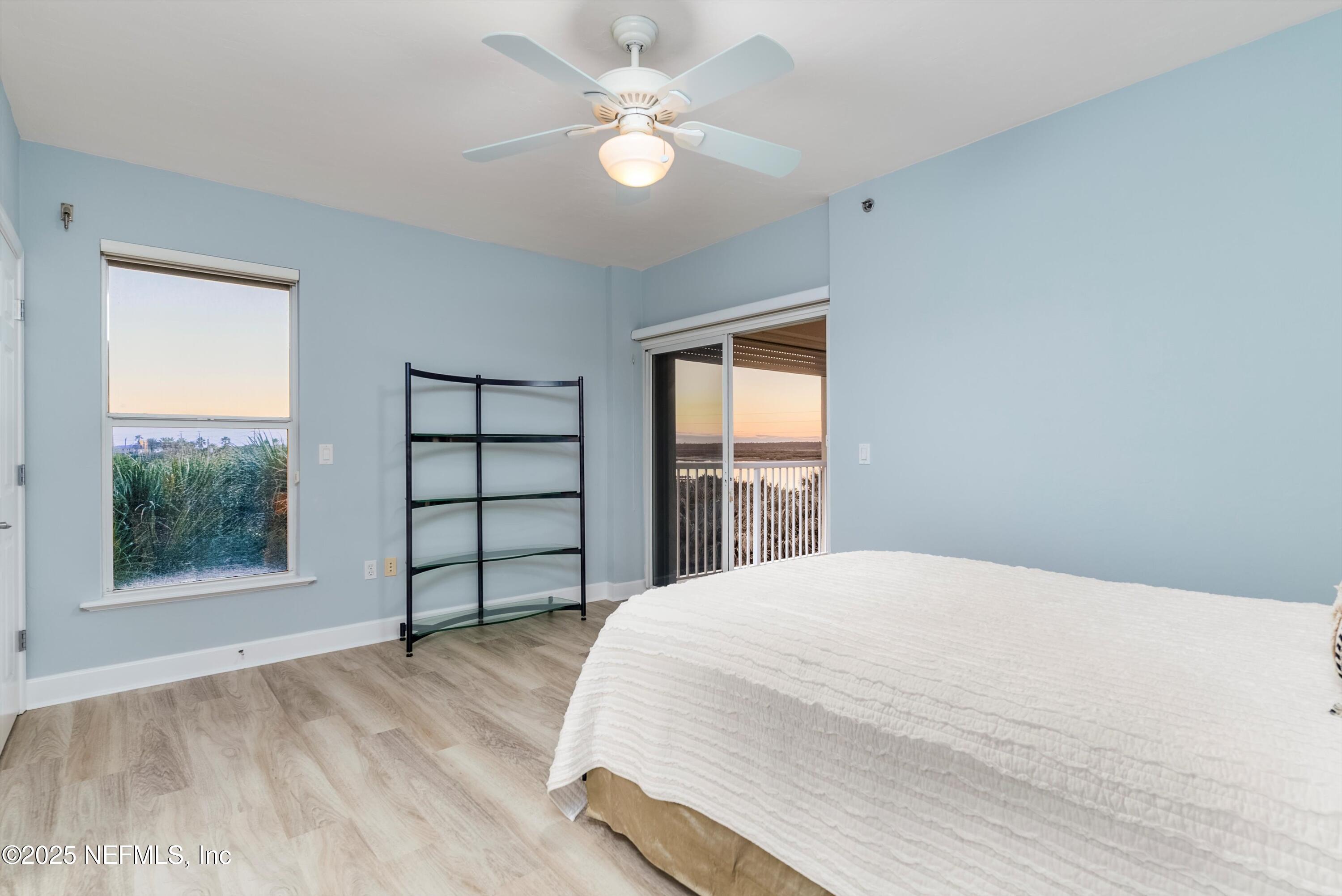 7790 A1A South, Unit 104 St. Augustine, FL 32080 - Photo 13 of 51 a bedroom with a large bed and a large window