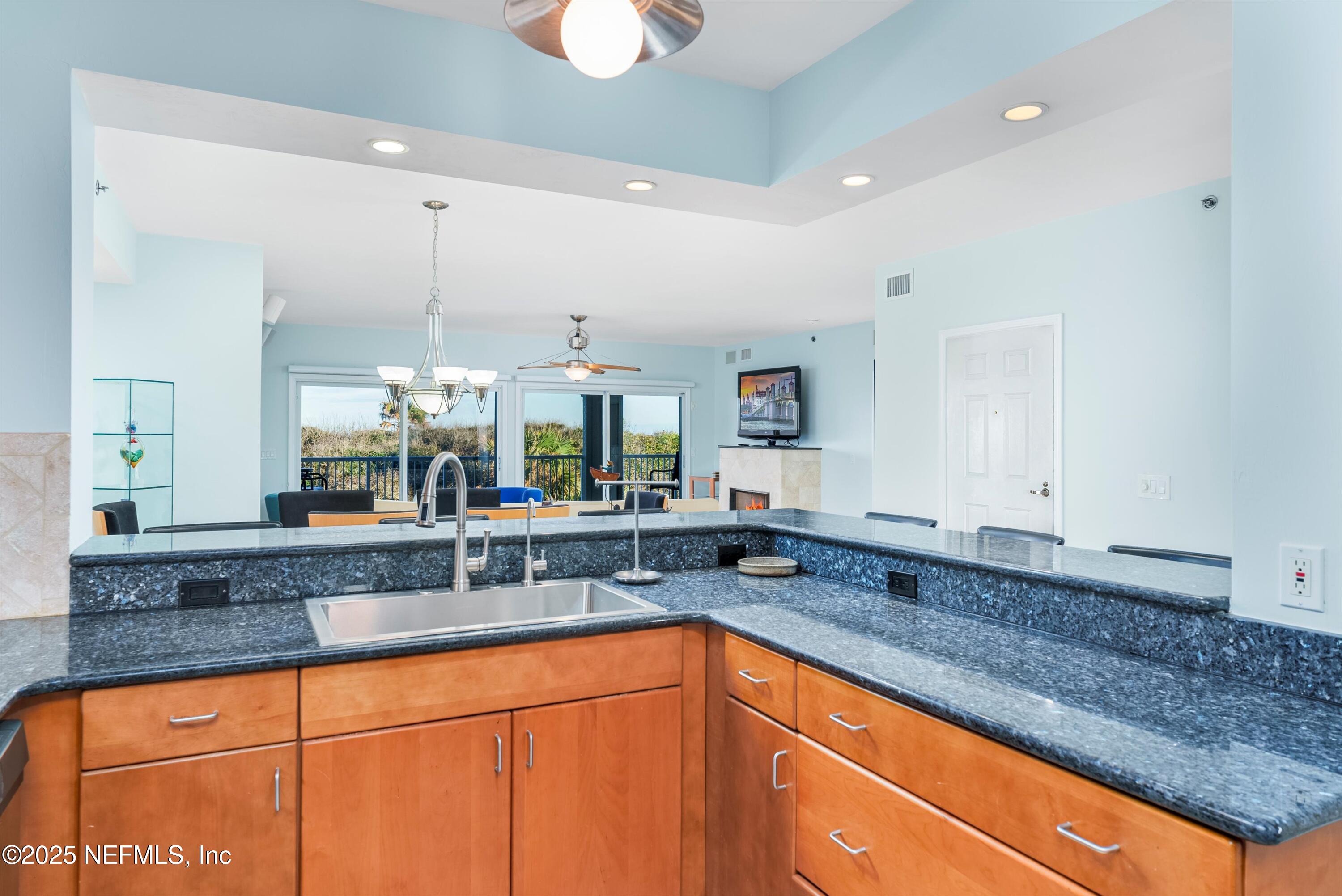 7790 A1A South, Unit 104 St. Augustine, FL 32080 - Photo 20 of 51 a kitchen with stainless steel appliances granite countertop a sink and a granite counter tops