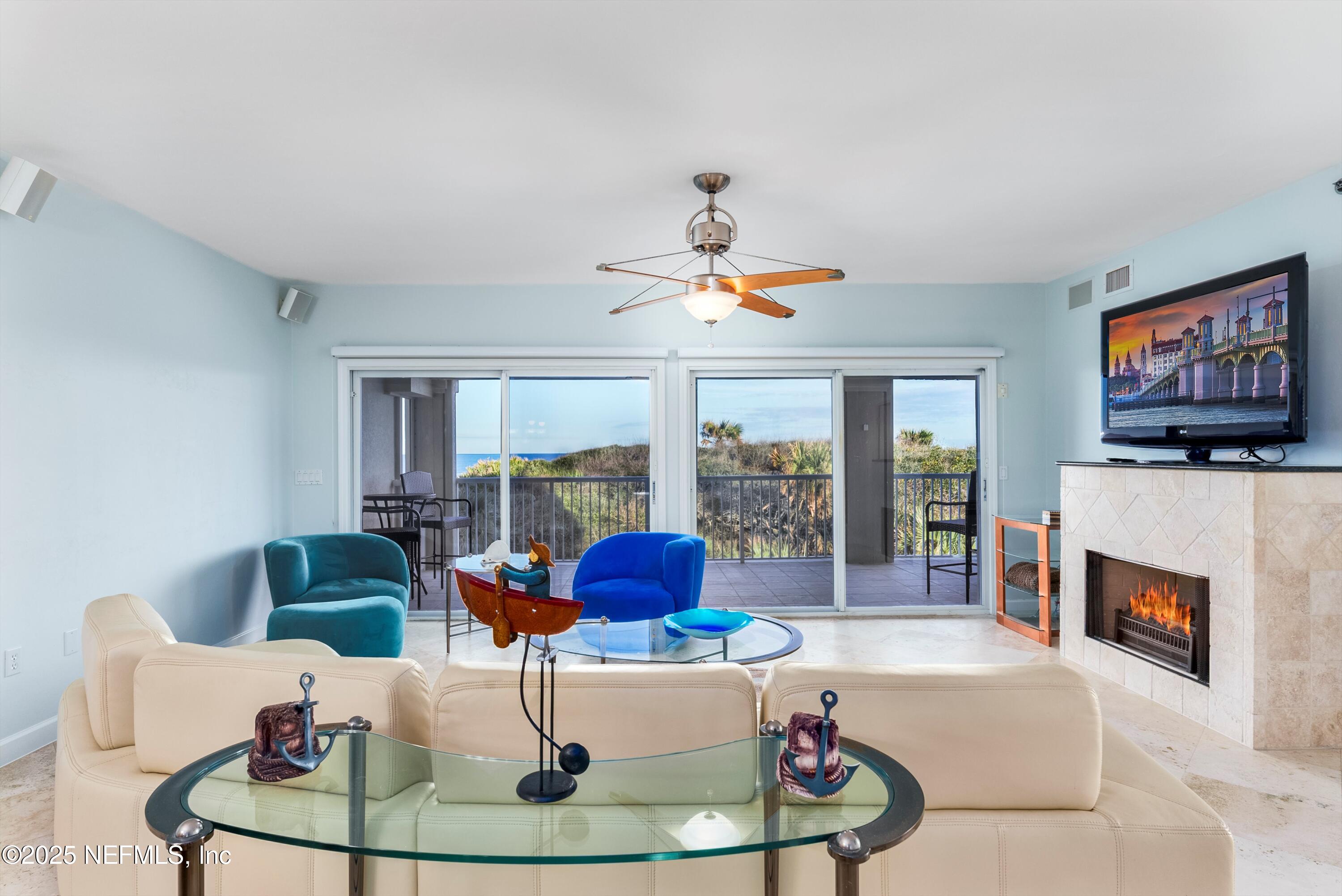 7790 A1A South, Unit 104 St. Augustine, FL 32080 - Photo 25 of 51 a living room with furniture and a fireplace