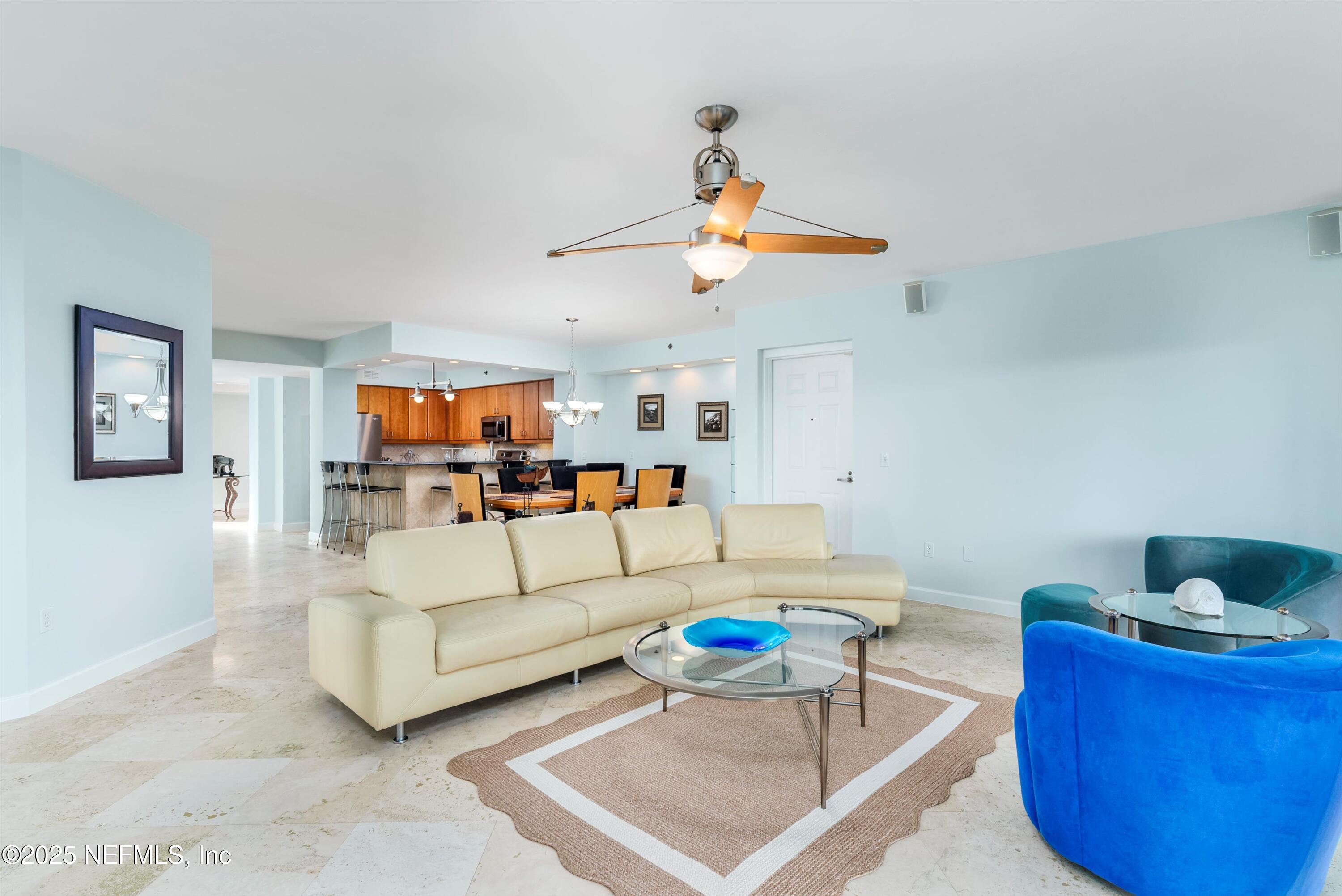 7790 A1A South, Unit 104 St. Augustine, FL 32080 - Photo 28 of 51 a living room with furniture kitchen view and a chandelier