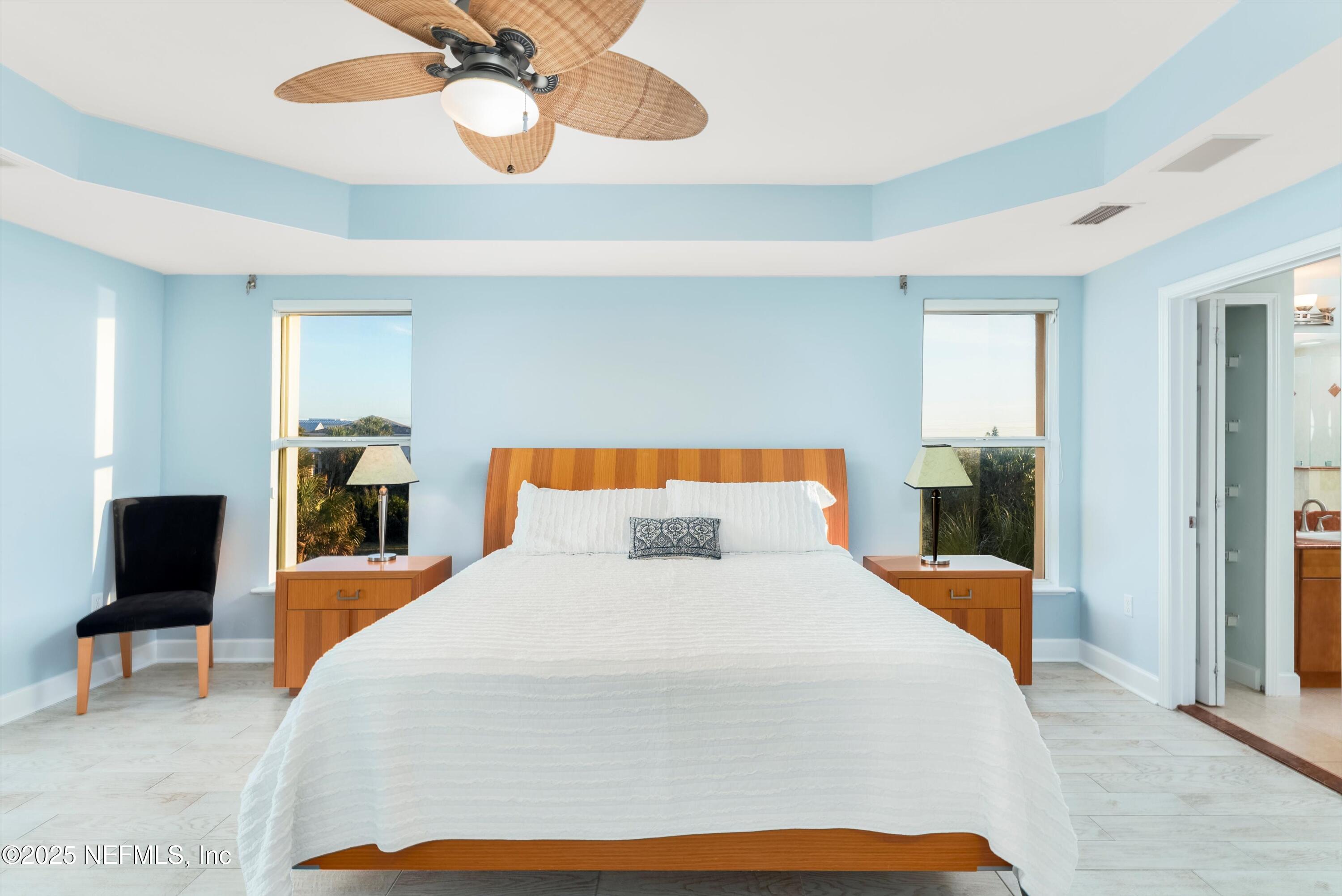 7790 A1A South, Unit 104 St. Augustine, FL 32080 - Photo 30 of 51 a bedroom with a bed and a large mirror