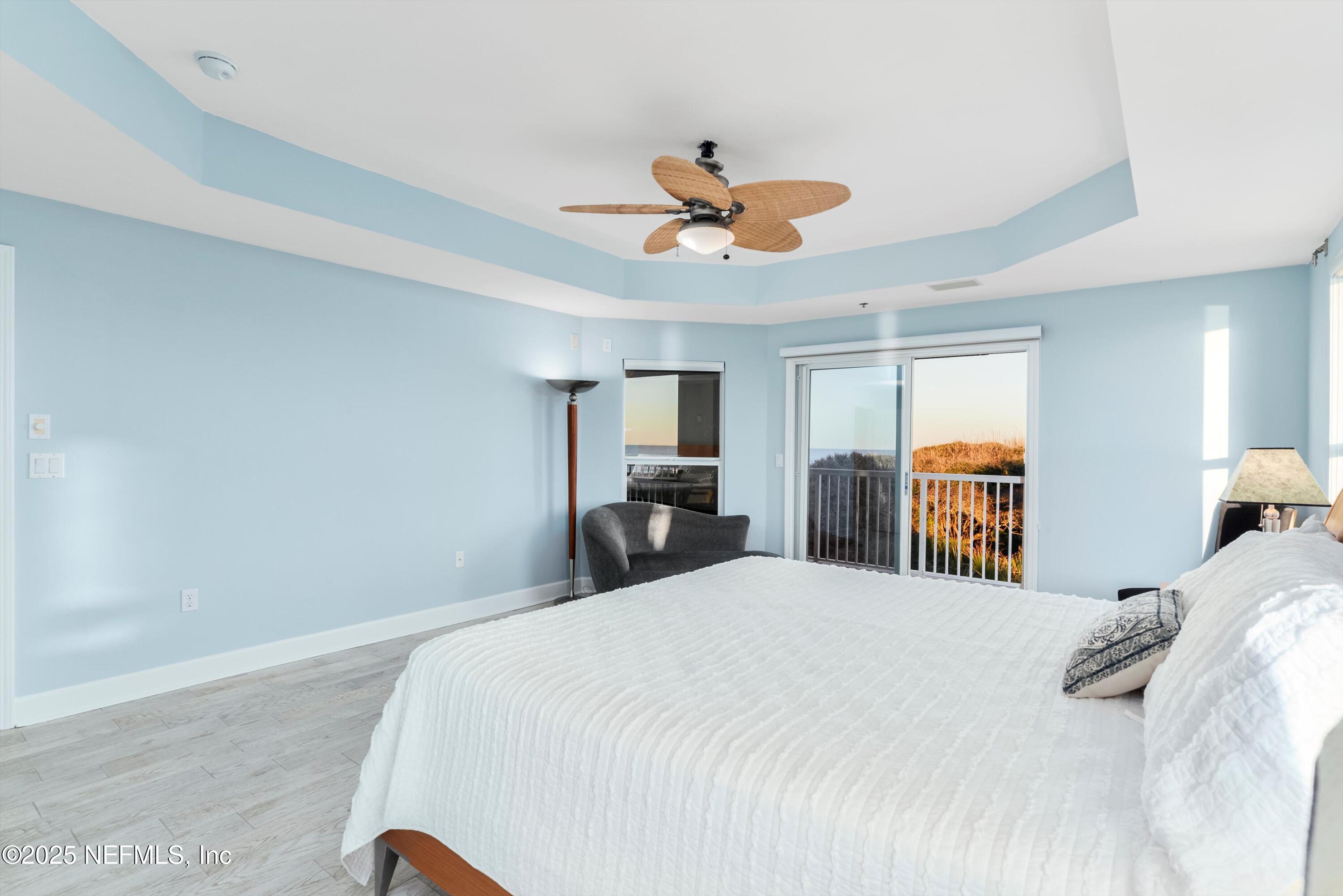 7790 A1A South, Unit 104 St. Augustine, FL 32080 - Photo 33 of 51 a bedroom with a large bed and a chandelier