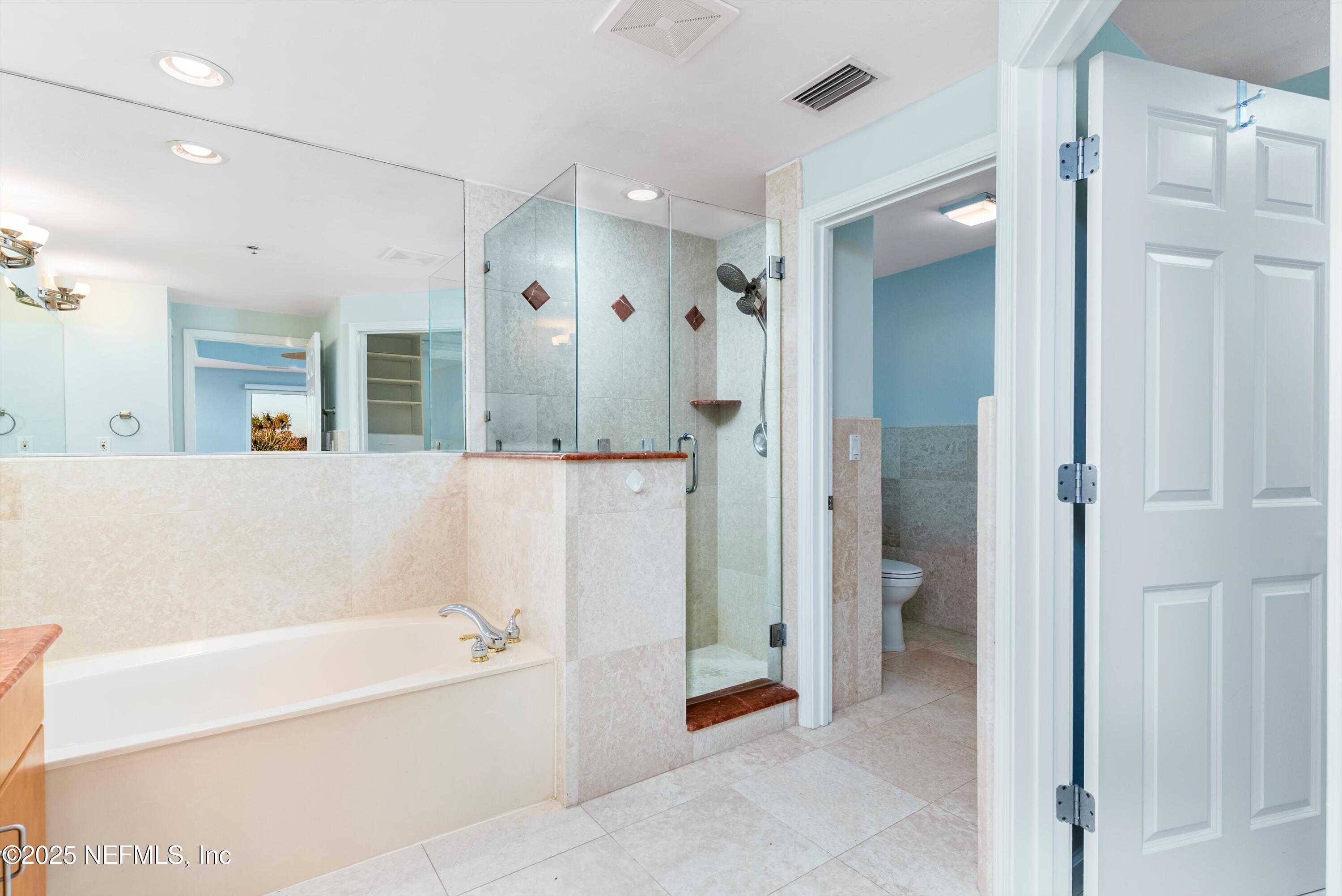 7790 A1A South, Unit 104 St. Augustine, FL 32080 - Photo 35 of 51 a bathroom with a bathtub and a shower