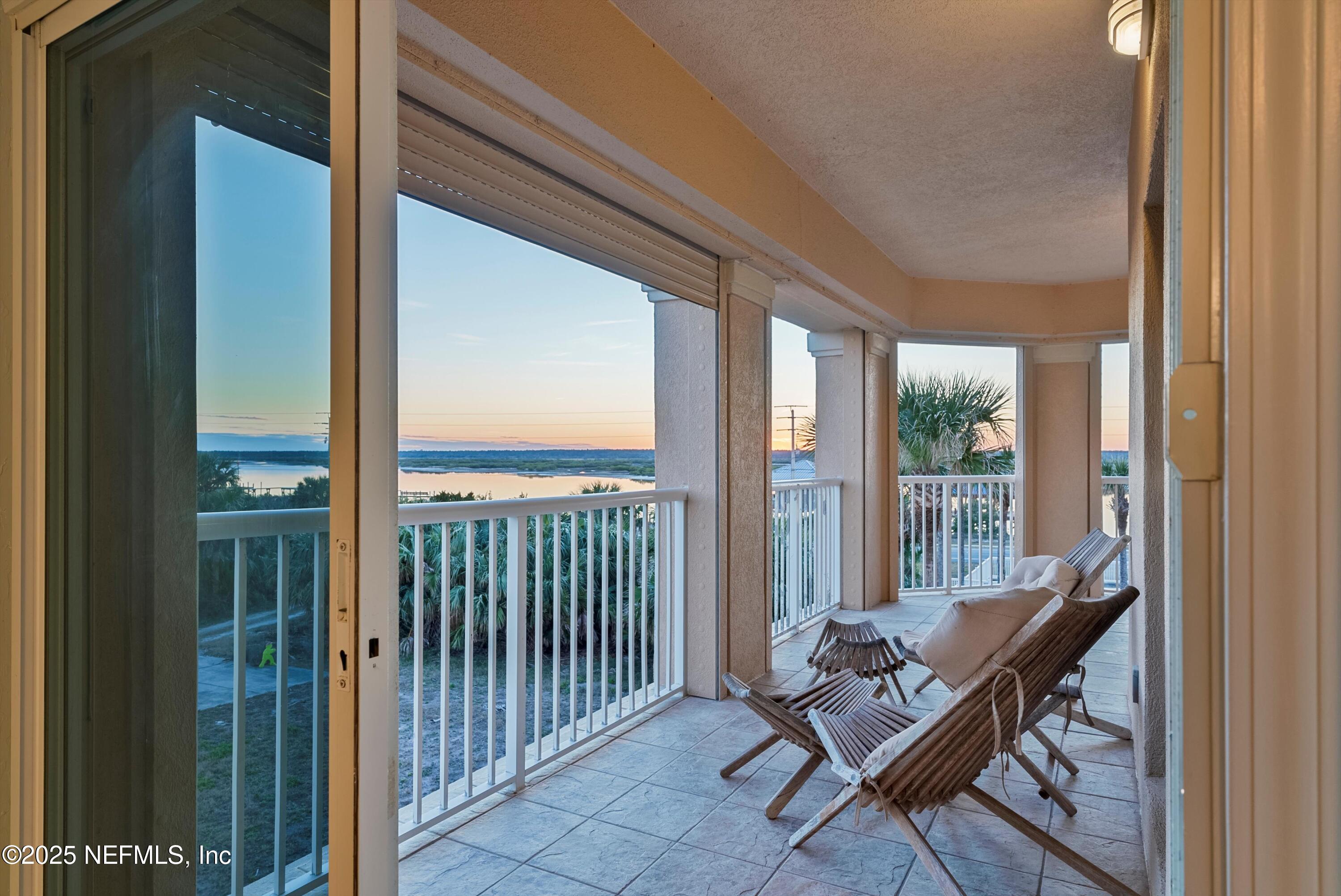 7790 A1A South, Unit 104 St. Augustine, FL 32080 - Photo 40 of 51 a living room with furniture and a floor to ceiling window
