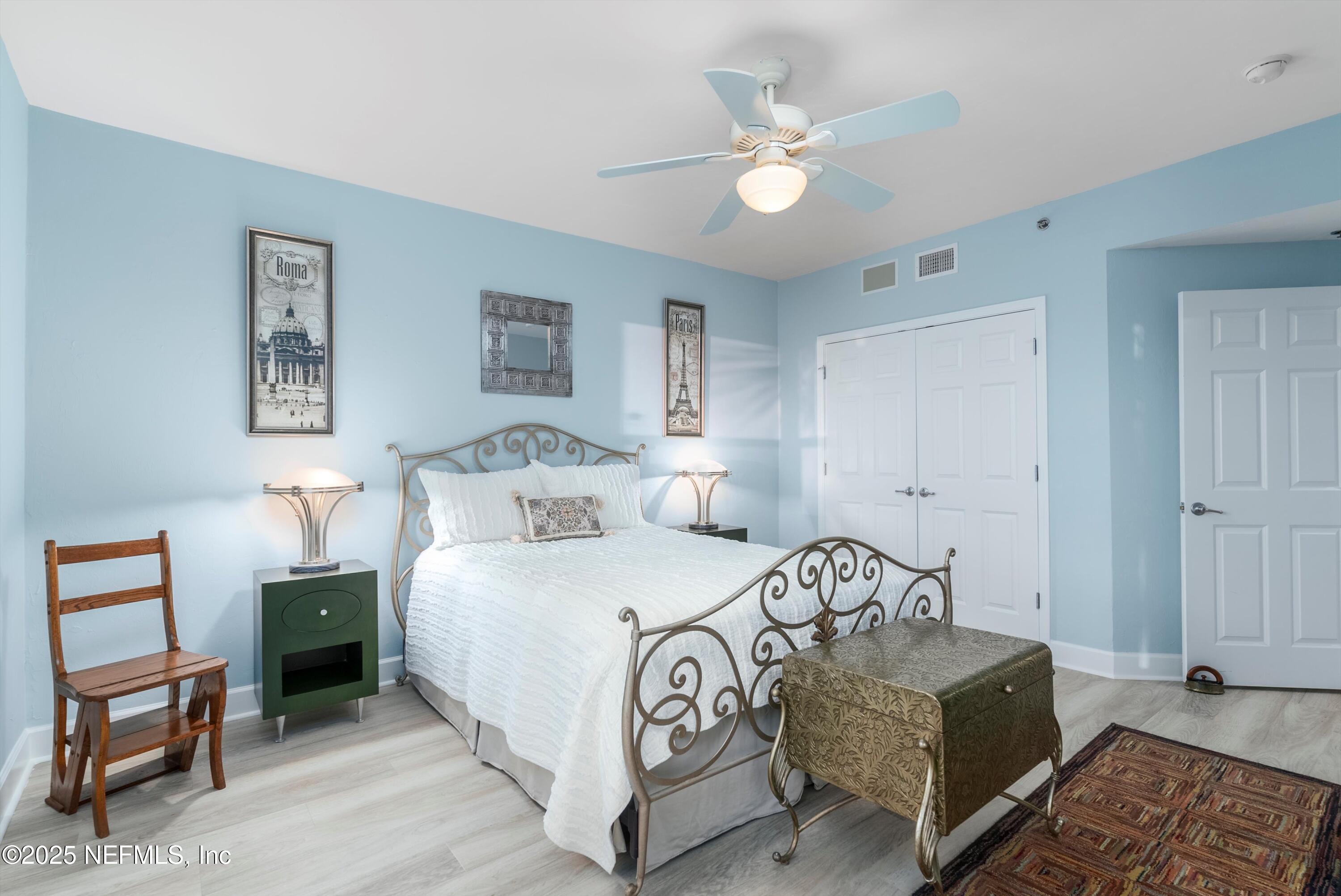 7790 A1A South, Unit 104 St. Augustine, FL 32080 - Photo 8 of 51 a bedroom with a bed and a chandelier