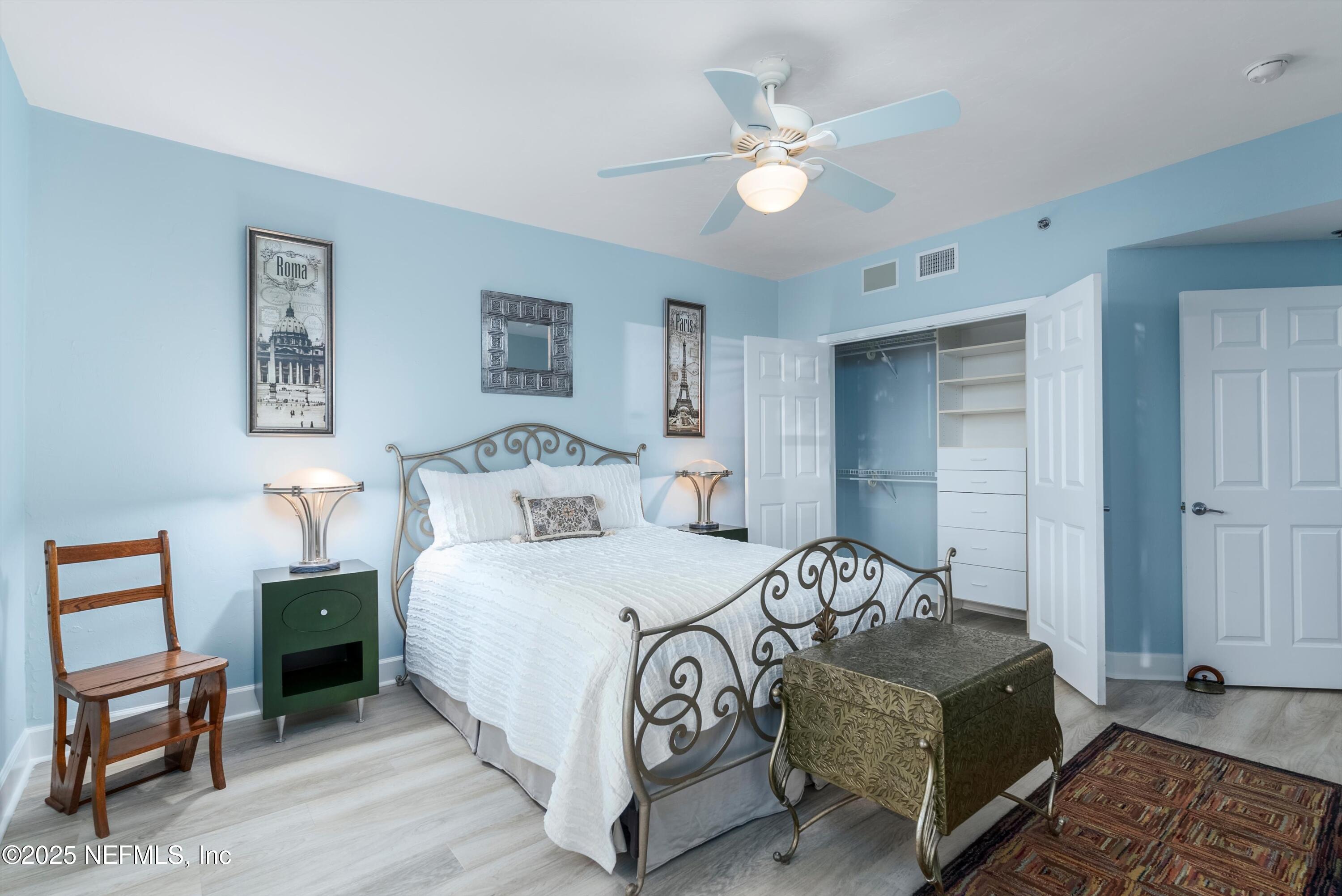 7790 A1A South, Unit 104 St. Augustine, FL 32080 - Photo 9 of 51 a bedroom with a bed and a chandelier