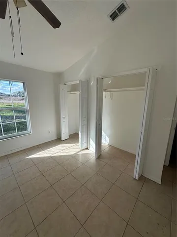 a bathroom with a granite countertop sink mirror vanity and toilet