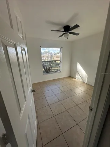 a view of an empty room and a window