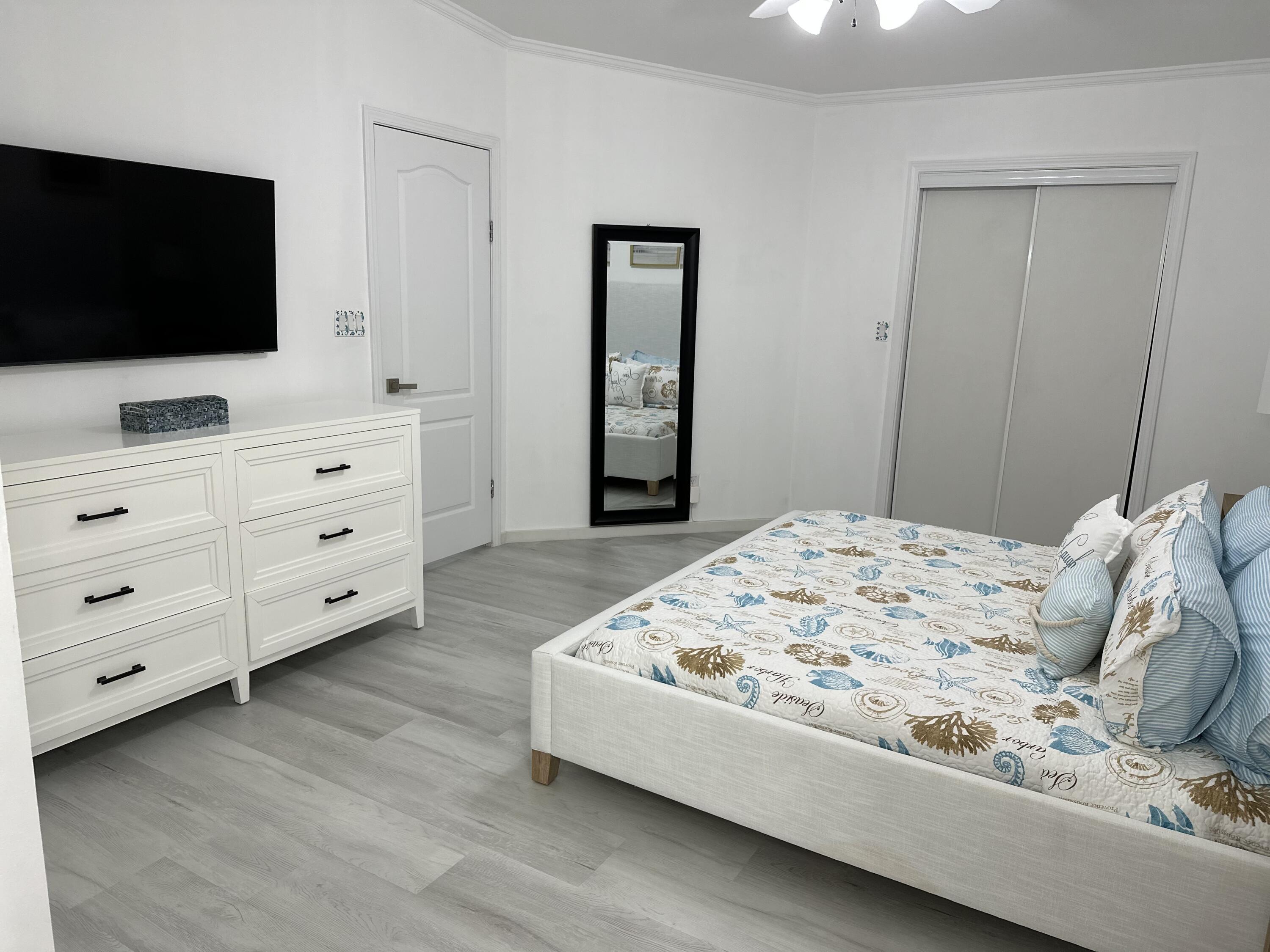 240 Taylor Drive Key Largo, FL 33037 - Photo 15 of 25 a bedroom with a bed and a flat screen tv